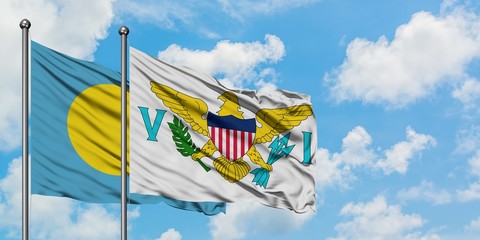 Fototapeta na wymiar Palau and United States Virgin Islands flag waving in the wind against white cloudy blue sky together. Diplomacy concept, international relations.