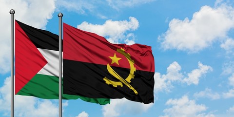 Palestine and Angola flag waving in the wind against white cloudy blue sky together. Diplomacy concept, international relations.