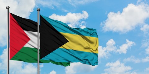 Palestine and Bahamas flag waving in the wind against white cloudy blue sky together. Diplomacy concept, international relations.