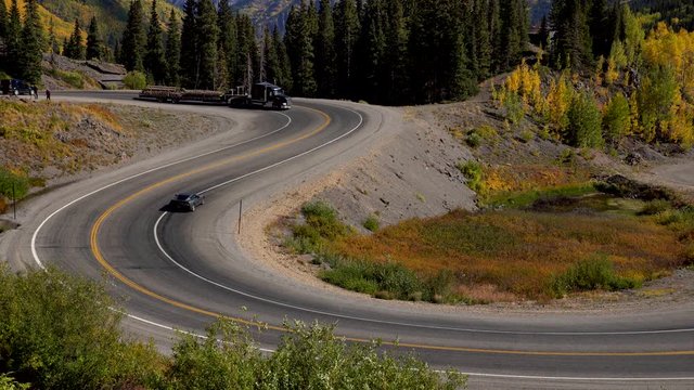 Closeup view of cars travelling on a curvy section of the Million Dollar Highway in the San Juan Mountains of Colorado