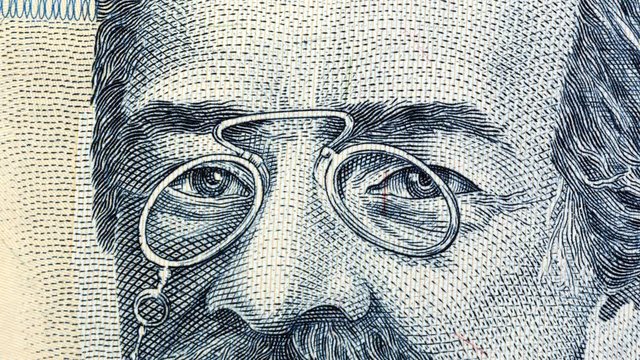 Eyes from portraits painted on money. Currency stop motion. World money detail.