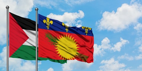 Palestine and Guadeloupe flag waving in the wind against white cloudy blue sky together. Diplomacy concept, international relations.