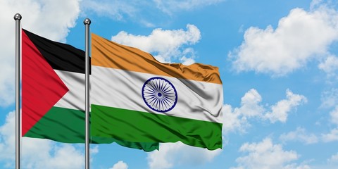 Palestine and India flag waving in the wind against white cloudy blue sky together. Diplomacy...
