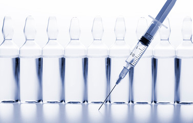 Glass medicine ampoules and Syringe on white background