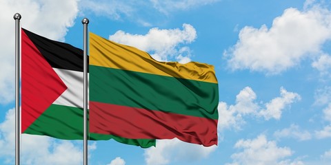Palestine and Lithuania flag waving in the wind against white cloudy blue sky together. Diplomacy concept, international relations.