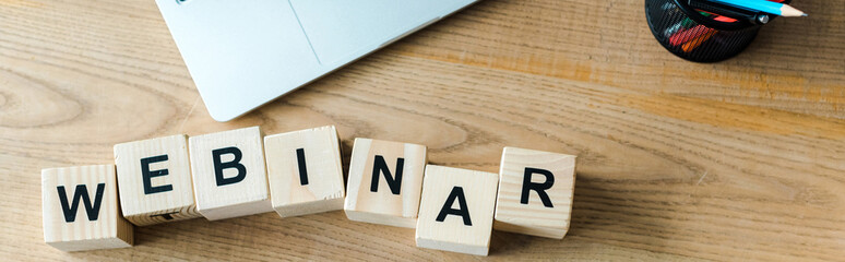 panoramic shot of wooden cubes with webinar letters