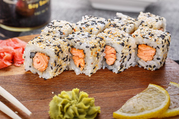 Rolls of red fish in the seeds of flax and sesame seeds