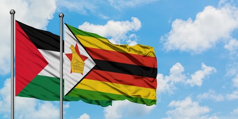 Palestine and Zimbabwe flag waving in the wind against white cloudy blue sky together. Diplomacy concept, international relations.