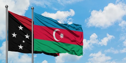 Papua New Guinea and Azerbaijan flag waving in the wind against white cloudy blue sky together. Diplomacy concept, international relations.