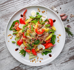 Salad of quail eggs, beans in pods, tomatoes, onions and other ingredients