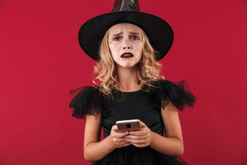 Upset little girl wearing Halloween witch costume