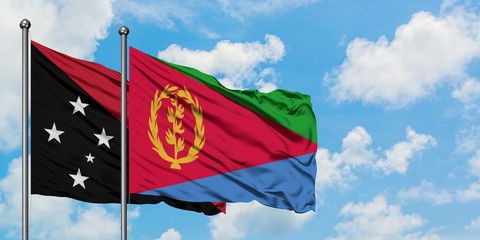 Papua New Guinea and Eritrea flag waving in the wind against white cloudy blue sky together. Diplomacy concept, international relations.