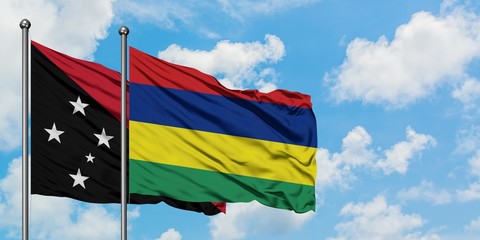 Papua New Guinea and Mauritius flag waving in the wind against white cloudy blue sky together. Diplomacy concept, international relations.