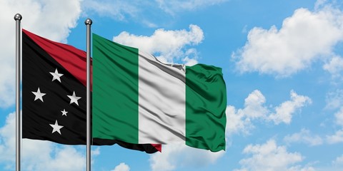 Papua New Guinea and Nigeria flag waving in the wind against white cloudy blue sky together. Diplomacy concept, international relations.