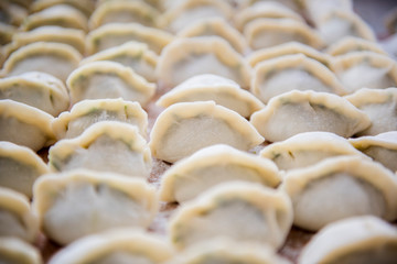 Chinese family traditional, ordinary food, just wrapped raw dumplings ready to pot.