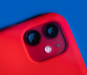 fragment close-up red iphone in a red case on a blue background
