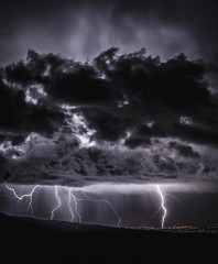 lightning over city and dark clouds 