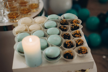Candy bar in mint color. Delicious sweets on candy buffet. Lot of colorful desserts on table. Selective focus