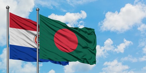 Paraguay and Bangladesh flag waving in the wind against white cloudy blue sky together. Diplomacy concept, international relations.