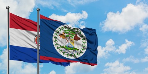 Paraguay and Belize flag waving in the wind against white cloudy blue sky together. Diplomacy concept, international relations.