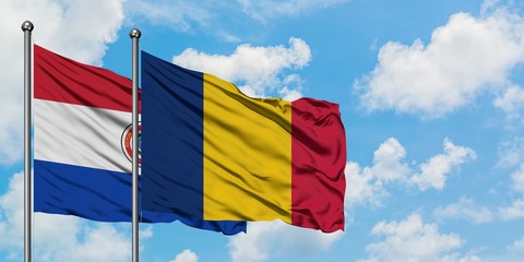 Paraguay and Chad flag waving in the wind against white cloudy blue sky together. Diplomacy concept, international relations.