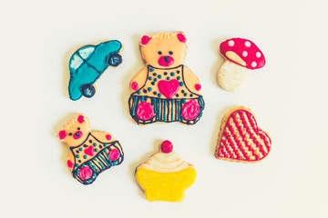 Collection of homemade various shapes gingerbread cookies on white background.