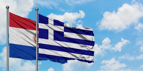 Paraguay and Greece flag waving in the wind against white cloudy blue sky together. Diplomacy concept, international relations.