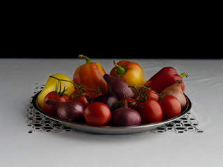 Fresh juicy vegetables as ingredients for a delicious autumn salad. Healthy eating Sprig with tomatoes, bell peppers, salad onions.