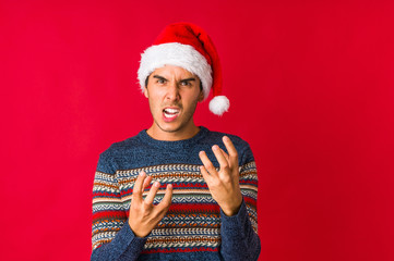 Young man on christmas day confused, feels doubtful and unsure.