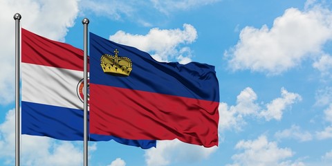 Paraguay and Liechtenstein flag waving in the wind against white cloudy blue sky together. Diplomacy concept, international relations.