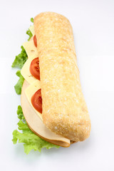 chicken sandwich, cheese and raw vegetables on a white background