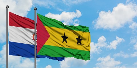 Paraguay and Sao Tome And Principe flag waving in the wind against white cloudy blue sky together. Diplomacy concept, international relations.