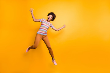 Fototapeta na wymiar Photo of cheerful positive pretty cute nice charming girlfriend wearing orange pants trousers striped t-shirt with astonishment on face isolated vibrant color background