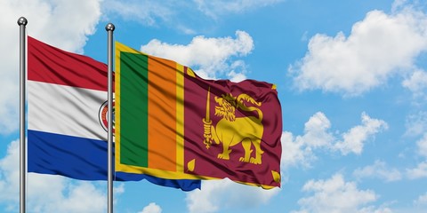 Paraguay and Sri Lanka flag waving in the wind against white cloudy blue sky together. Diplomacy concept, international relations.