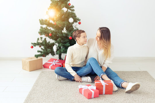 Single Parent And Holidays Concept - Portrait Of Mother Celebrating Christmas At Home On Christmas Eve