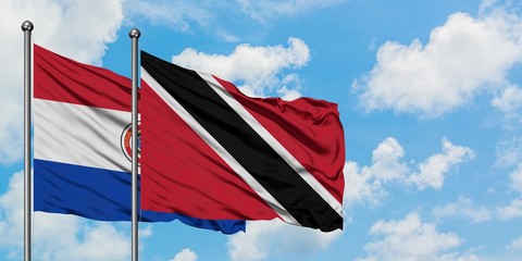 Paraguay and Trinidad And Tobago flag waving in the wind against white cloudy blue sky together. Diplomacy concept, international relations.