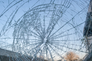 broken car windshield with a hole in the center of the image. background, texture