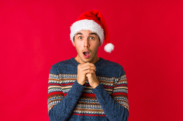 Young man on christmas day laughing and having fun.