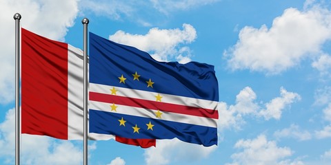 Peru and Cape Verde flag waving in the wind against white cloudy blue sky together. Diplomacy concept, international relations.