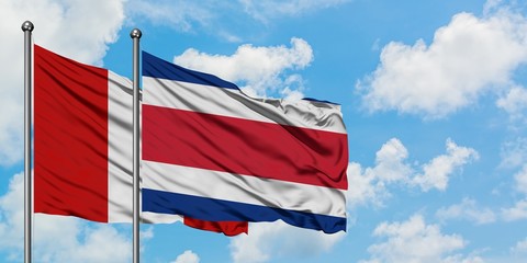 Peru and Costa Rica flag waving in the wind against white cloudy blue sky together. Diplomacy concept, international relations.