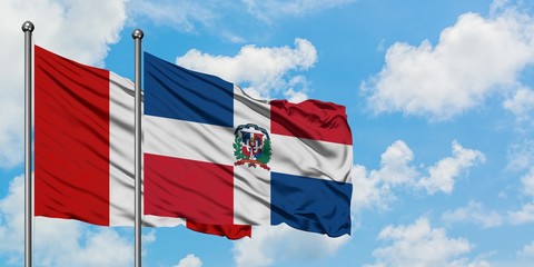 Peru and Dominican Republic flag waving in the wind against white cloudy blue sky together. Diplomacy concept, international relations.