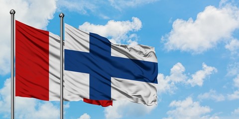 Peru and Finland flag waving in the wind against white cloudy blue sky together. Diplomacy concept, international relations.