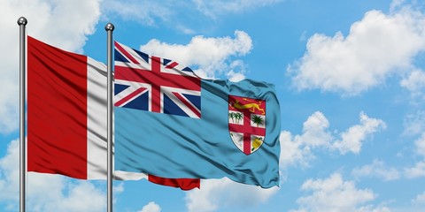 Peru and Fiji flag waving in the wind against white cloudy blue sky together. Diplomacy concept, international relations.