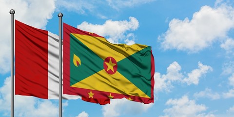 Peru and Grenada flag waving in the wind against white cloudy blue sky together. Diplomacy concept, international relations.