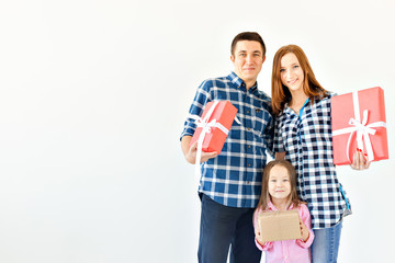 Holidays and celebration concept - Happy family with Christmas presents on white background with copy space