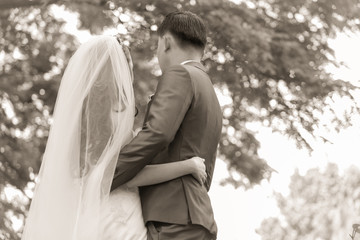 Married bride and groom embracing each other as a symbol of love