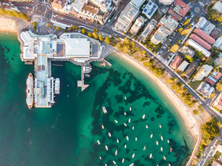 Vertical bird's eye aerial evening drone view of Manly wharf, part of the oceanside suburb of...