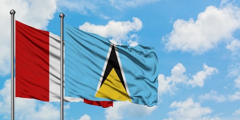 Peru and Saint Lucia flag waving in the wind against white cloudy blue sky together. Diplomacy concept, international relations.