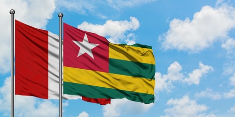Peru and Togo flag waving in the wind against white cloudy blue sky together. Diplomacy concept, international relations.