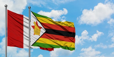Peru and Zimbabwe flag waving in the wind against white cloudy blue sky together. Diplomacy concept, international relations.